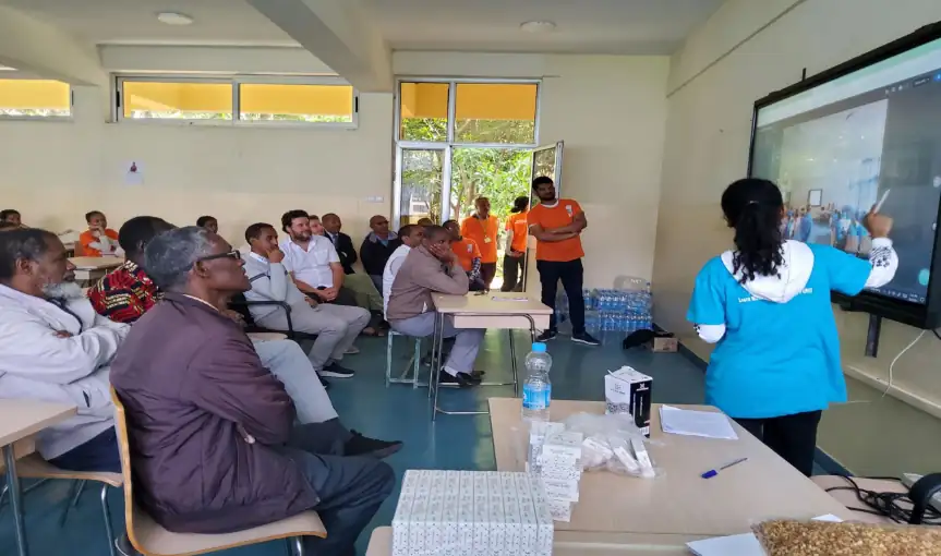 Fig: The camp closing assembly showing printed VMC Card Decks in the Background