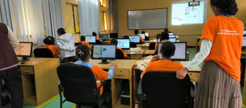 Fig: Showing students programming using Blockly by Google. The Camp was a low resource, high innovation environment.